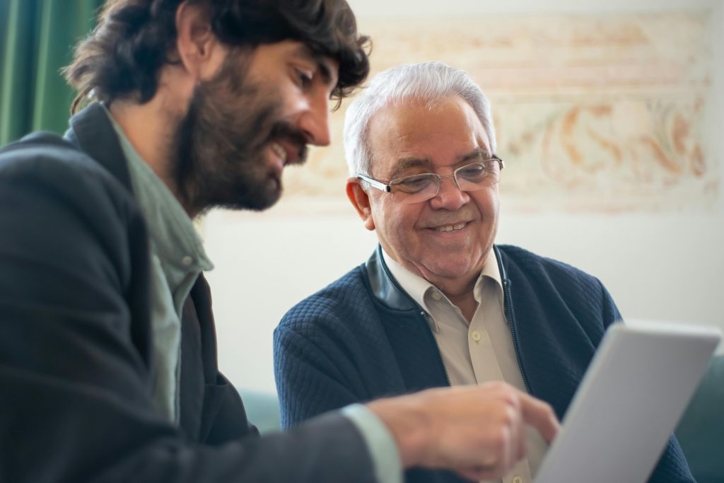 Elderly Man Discussing Business With A Younger Colleague Using A Laptop Indoors G AAklRSAaj3KmpGaiZUBw 1024x683